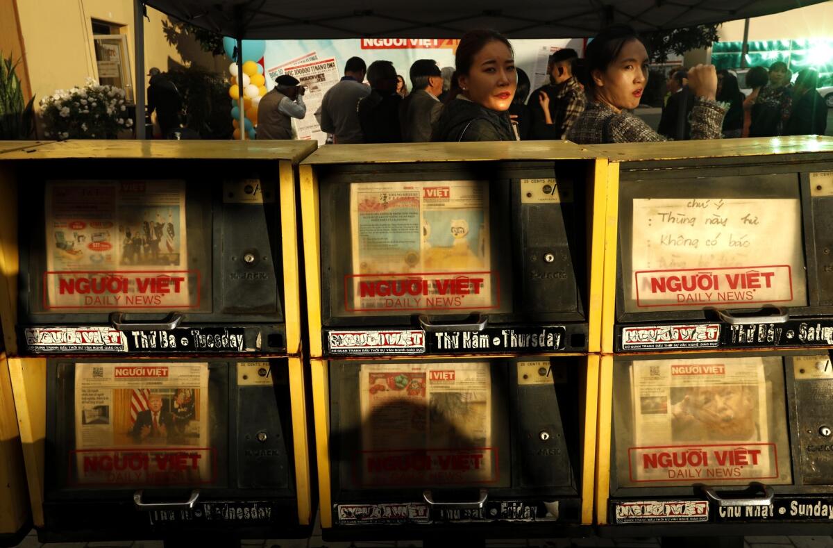 WESTMINSTER, CA - JANUARY 12, 2019 - - News stands carrying issues of the Nguoi Viet Daily News, stand in a row as staff and community members celebrate as the newspaper turns 40 in Little Saigon in Westminster on January 12, 2019. Nguoi Viet Daily News is the first Vietnamese-language daily newspaper in the United States. The newspaper was started by Yen Ngoc Do in 1978. Its name derives from ngu?i Vi?t, meaning "Vietnamese people". Nguoi Viet Daily News began as a weekly four-page newspaper. The first issue, dated December 15, 1978, was printed in Do's garage in Orange County, California with the assistance of his entire family. Do financed the initial press run of 2,000 copies with $4,000 of his own savings. team of five reporters covers local news in Little Saigon, as well as Vietnamese communities throughout the country and abroad. Today, the newspaper has continued in the same spirit imparted by Do. (Genaro Molina/Los Angeles Times)