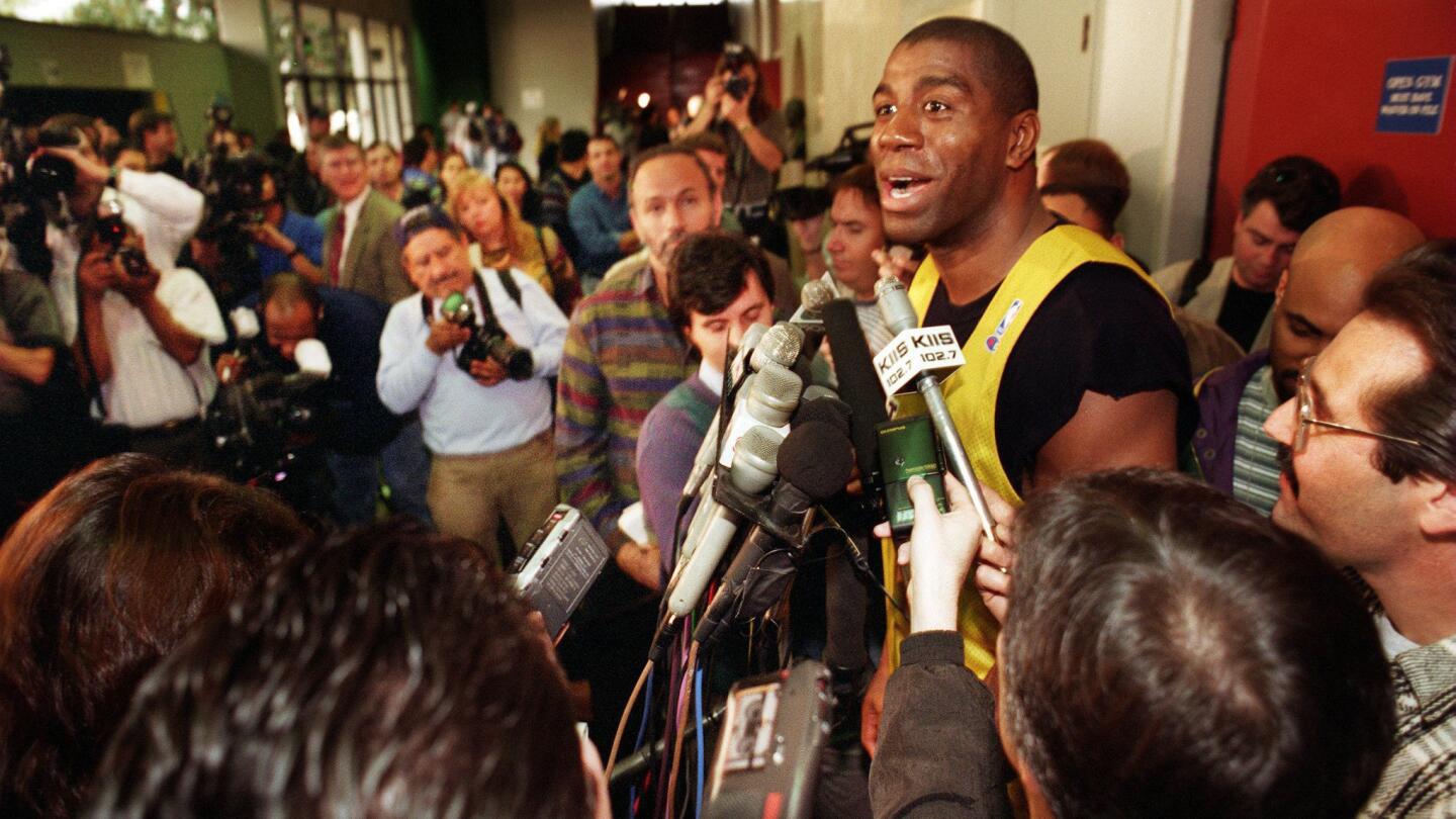 Lakers great Magic Johnson speaks with reporters following a personal practice session at Loyola Marymount in January 1996.