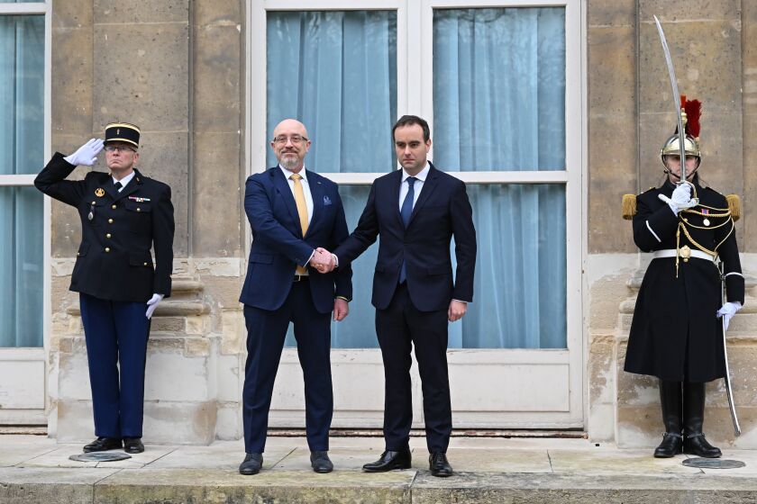 French Defense Minister Sebastien Lecornu, center right, and Ukrainian Minister of Defense Oleksii Reznikov pose during Reznikov's official visit at the French Defense Ministry, in Paris Tuesday, Jan. 31, 2023. Ukraine's defense minister pays his first official visit to France, meeting with Macron and the defense minister, as Ukraine sets its sights on Western warplanes and other heavy weaponry to push back Russian forces. (Julie Sebadelha, Pool via AP)