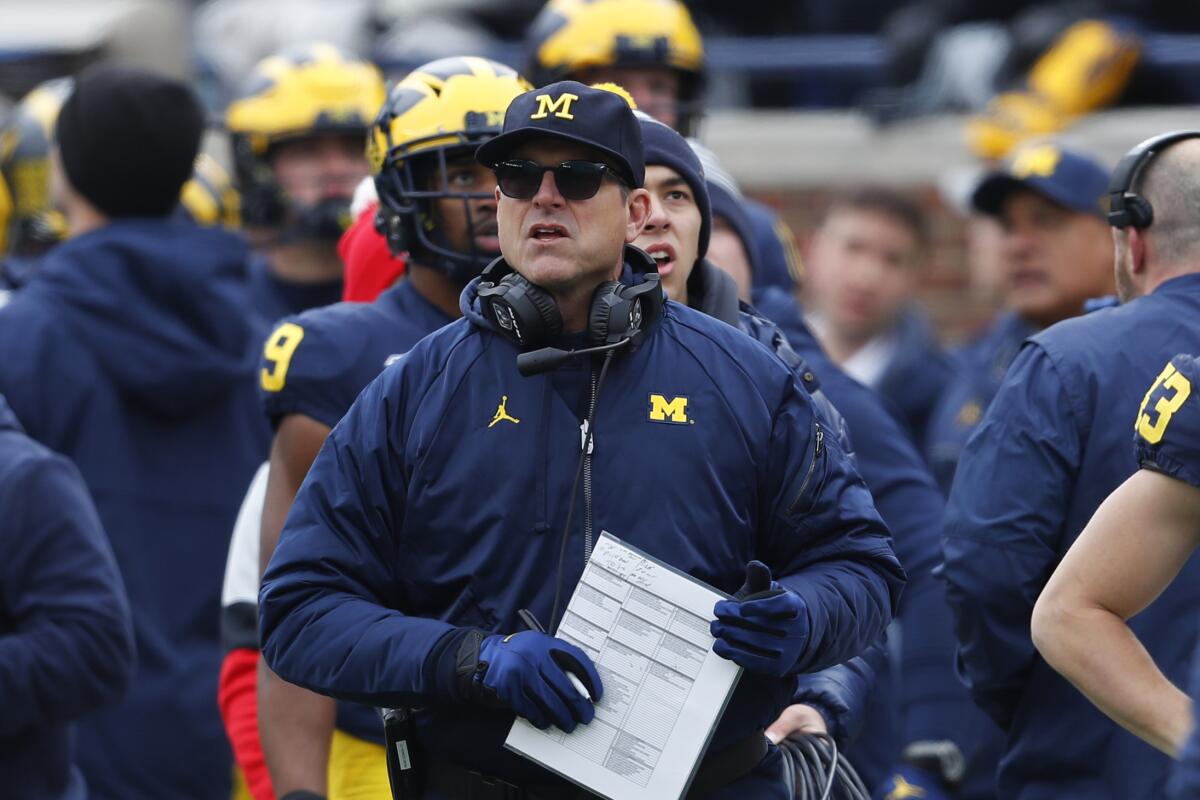 FILE - In this Nov. 30, 2019, file photo, Michigan head coach Jim Harbaugh watches.