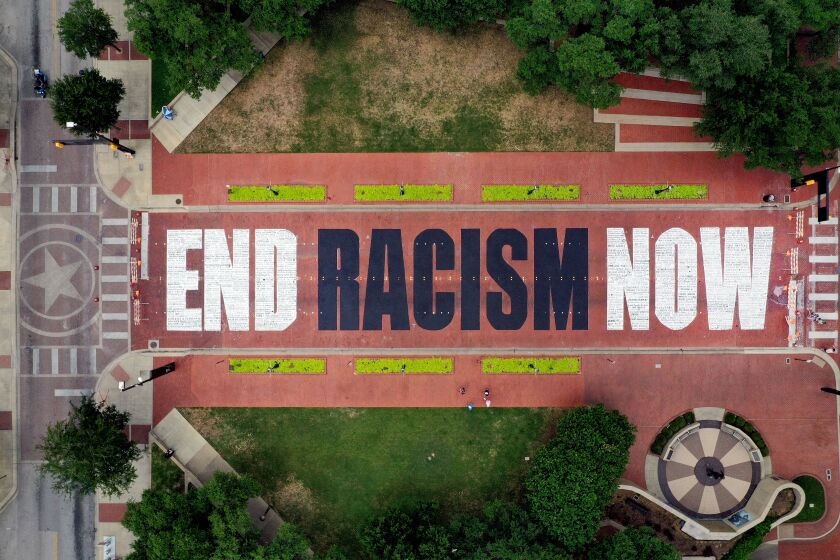 FORT WORTH, TEXAS - JUNE 28: An aerial view from a drone as residents view the "End Racism Now" mural painted on Main Street in downtown on June 28, 2020 in Fort Worth, Texas. Local artists partnered with volunteers to paint the message after being inspired by the Black Lives Matter movement and recent protest following the death of George Floyd. (Photo by Tom Pennington/Getty Images)