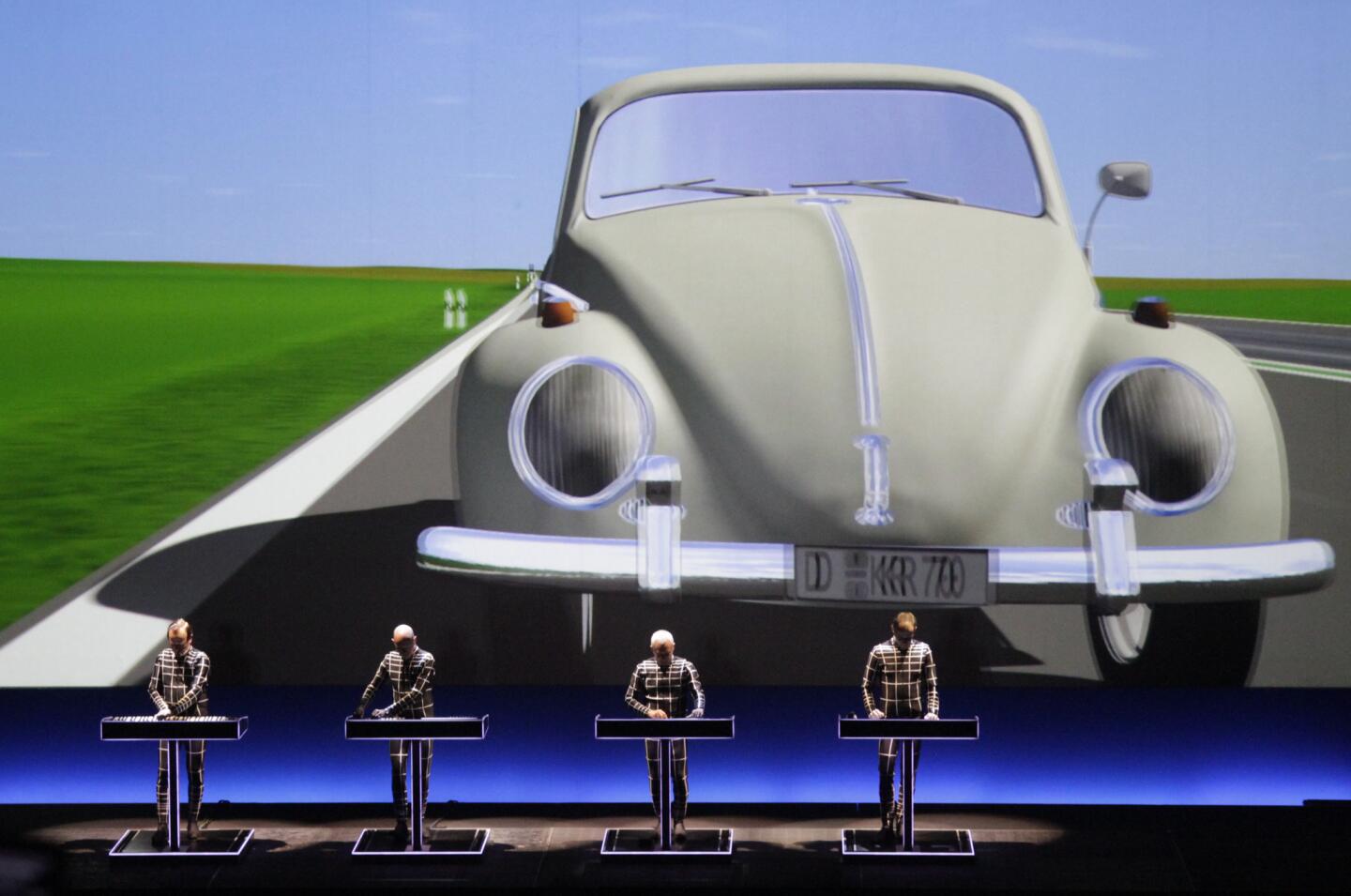 Identically dressed members of Kraftwerk perform their album "Autobahn" at Walt Disney Concert Hall in Los Angeles on March 18, 2014. 3-D glasses are needed to truly appreciate the graphics behind band members.