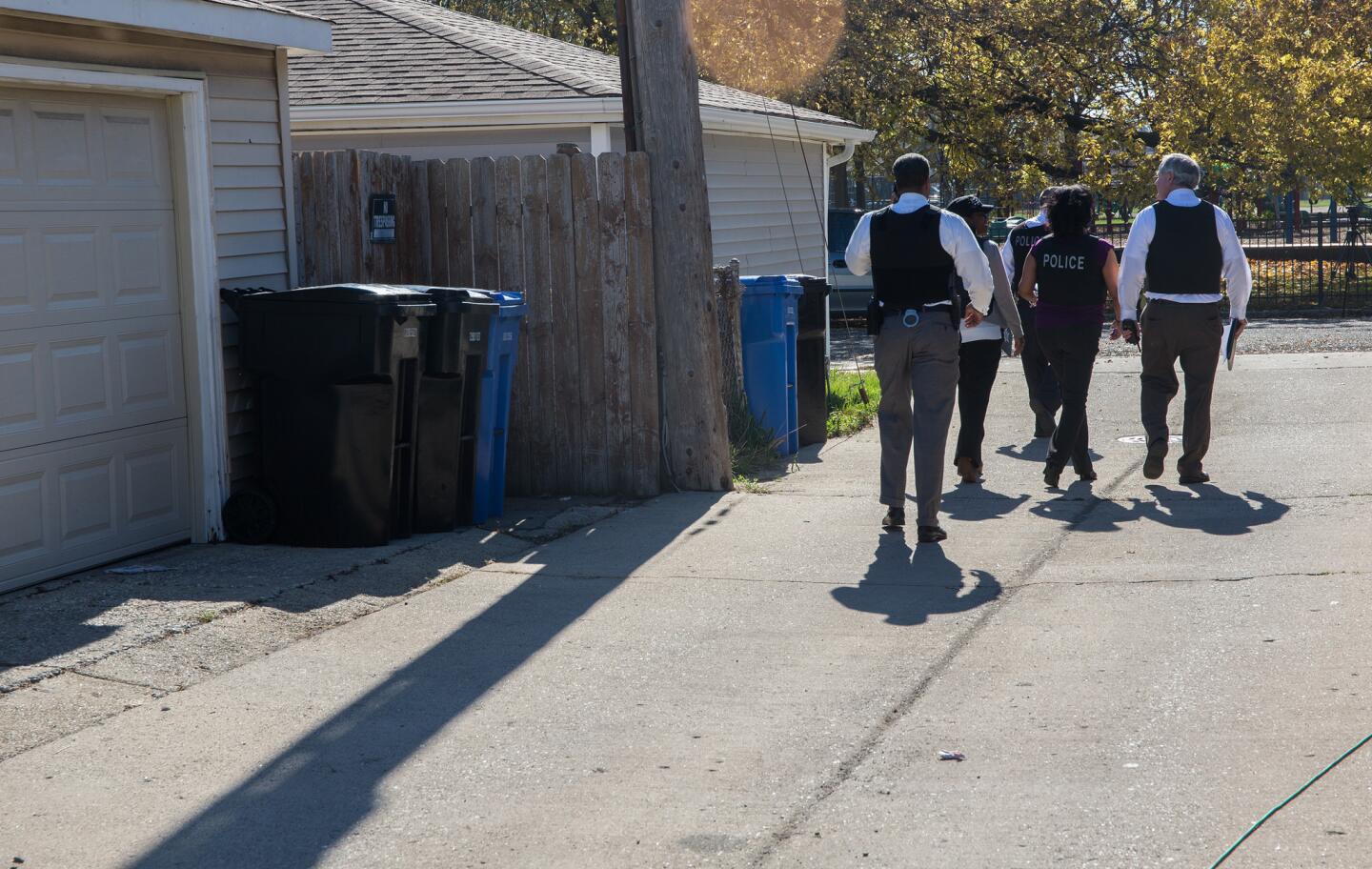Chicago police officers investigate Nov. 3, 2015, in the alley at 80th Street and South Damen Avenue, near where Tyshawn Lee, 9, was fatally shot the day before.