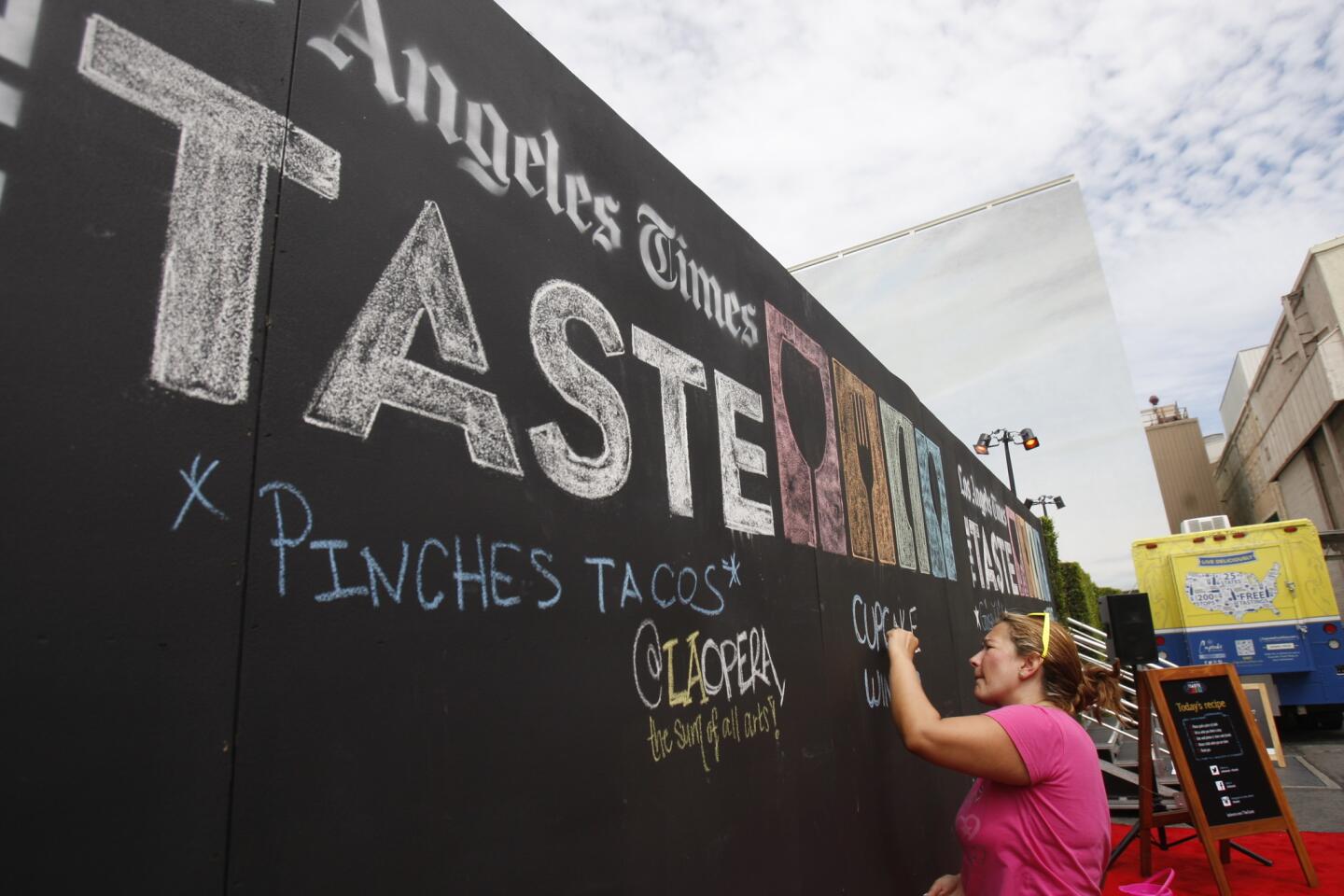 Helga Oliveros draws on the "What are you tasting?" wall at the 2013 event.