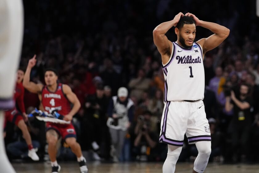 Kansas State's Markquis Nowell (1) reacts after Florida Atlantic players celebrate after defeating Kansas State in an Elite 8 college basketball game in the NCAA Tournament's East Region final, Saturday, March 25, 2023, in New York. (AP Photo/Frank Franklin II)