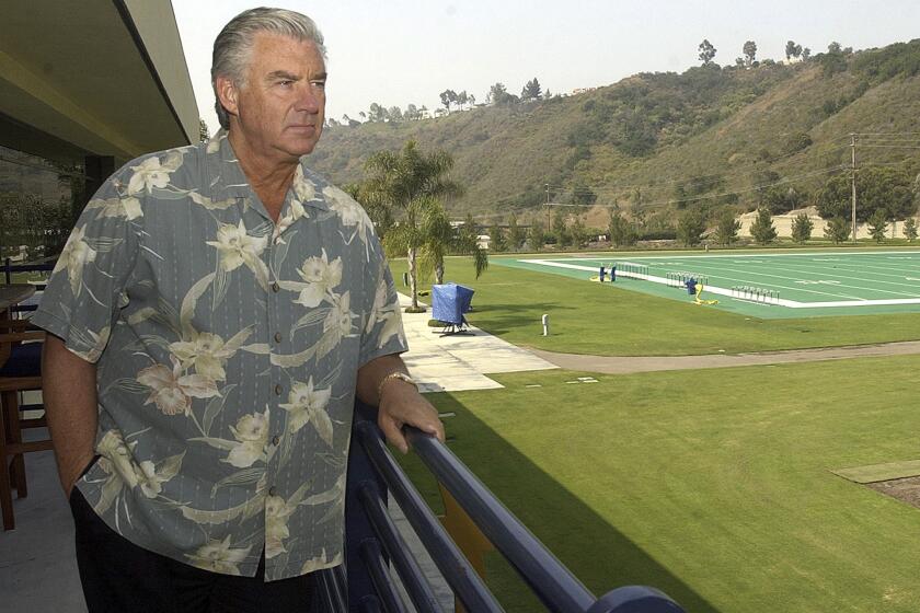 San Diego Chargers general manager A.J. Smith stares out at the Chargers practice , July 9, 2003,
