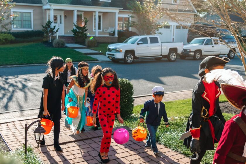 Boys and girls trick or treating on Halloween