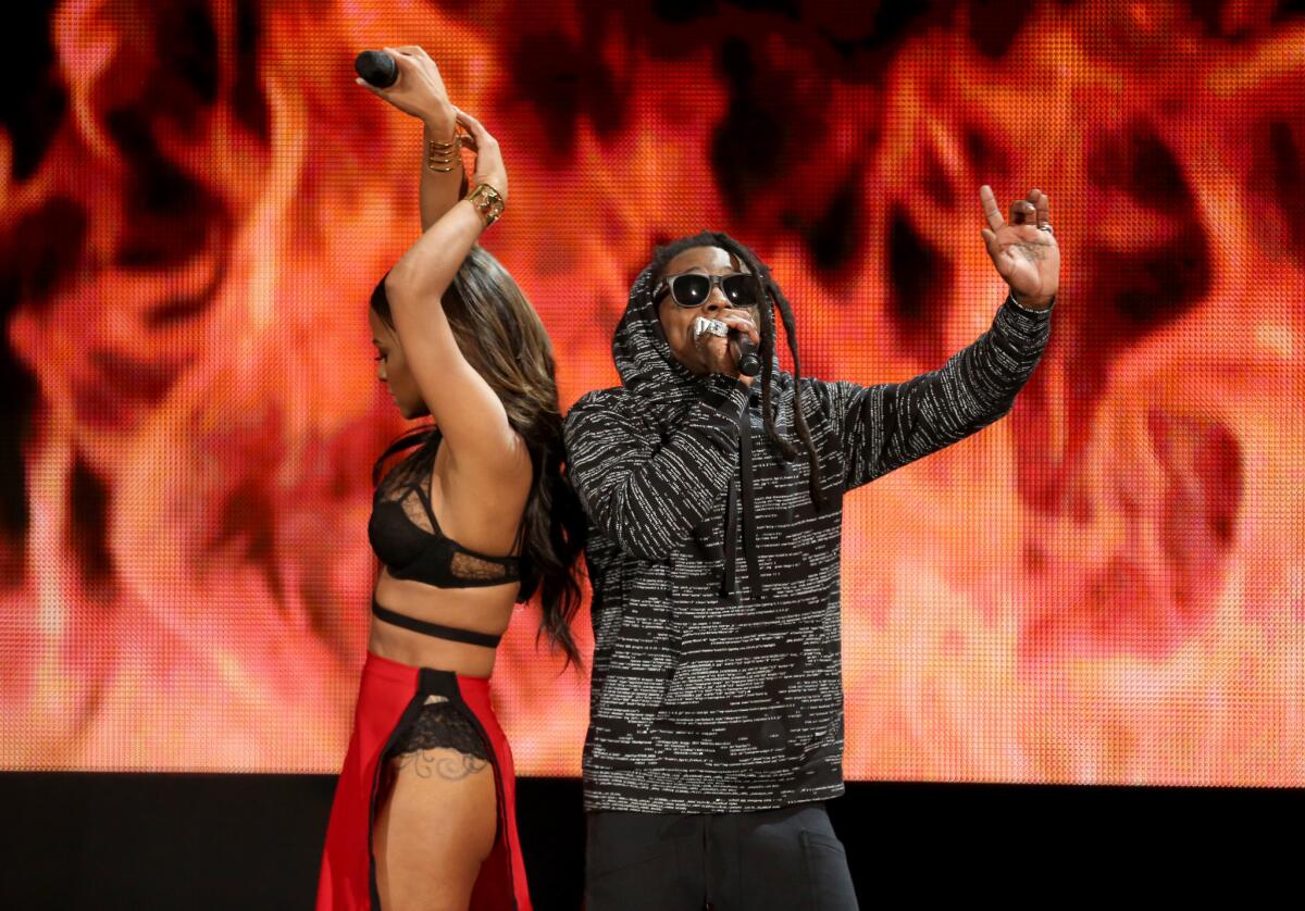 Christina Milian and Lil Wayne perform at the American Music Awards at the Nokia Theatre on Nov. 23.
