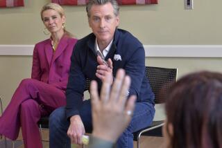 California Gov. Gavin Newsom with first partner Jennifer Newsom, left, calls on a student from New College of Florida on Wednesday, April 6, 2023, during the governor's stop at the Betty J. Johnson North Sarasota Public Library in Sarasota, Fla. Newsom was critical of Florida Gov. Ron DeSantis over his attempt to transform the liberal arts college. (Mike Lang/Sarasota Herald-Tribune via AP)