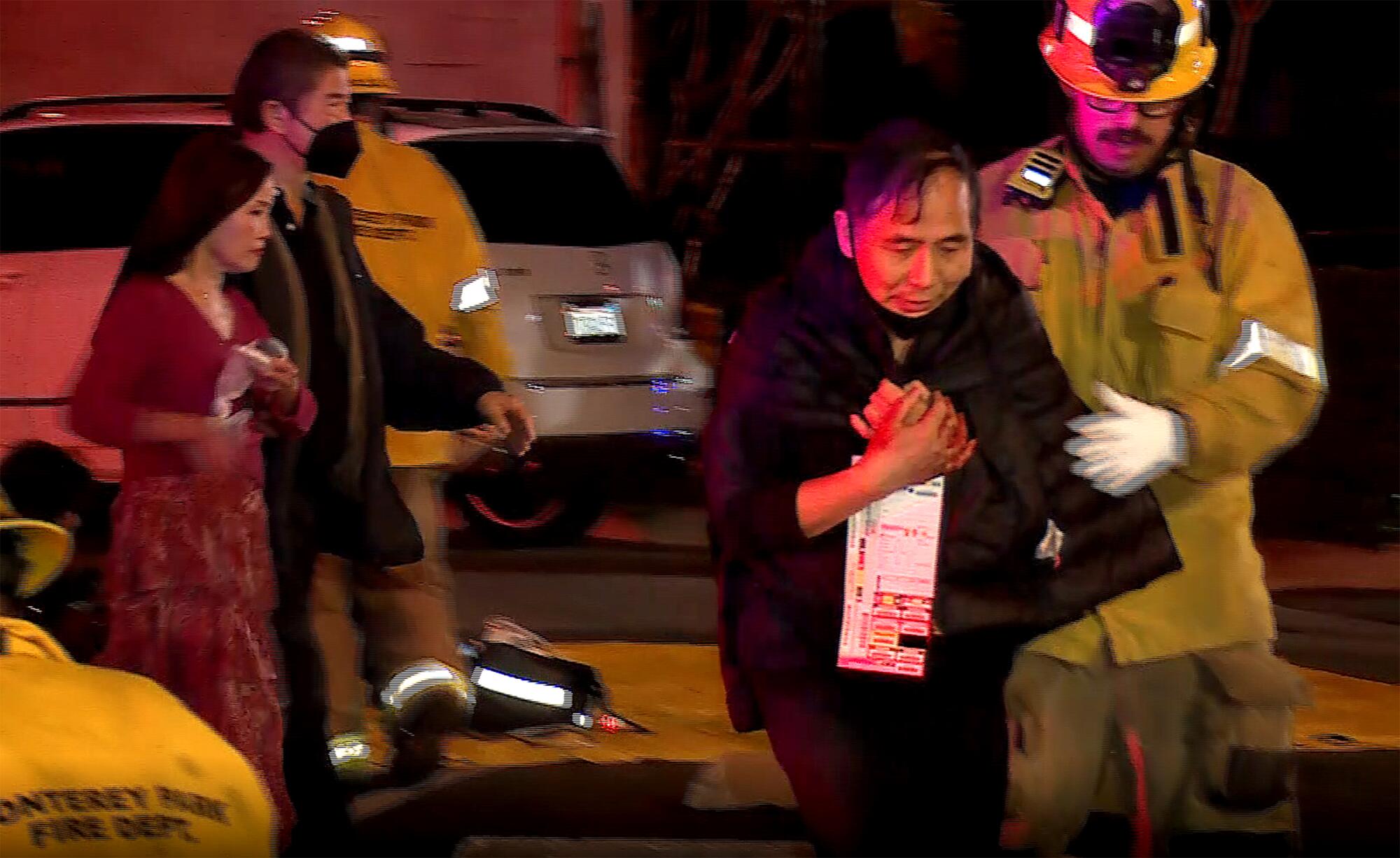 People are escorted from the shooting scene in Monterey Park.