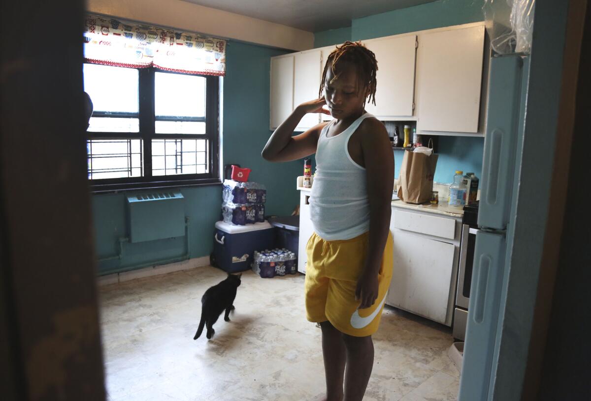 Mason Washington stands in the kitchen