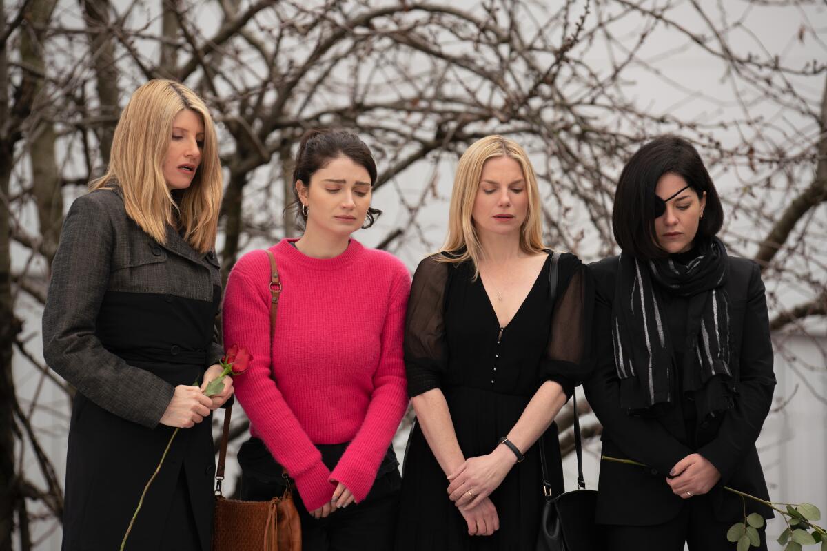 Four sisters looking sad in a wintry landscape in a scene from "Bad Sisters."
