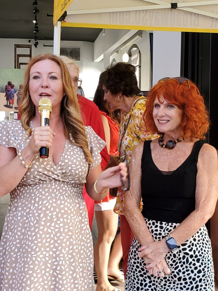 La Jolla Village Merchants Association board President Amber Anderson (left) and Executive Director Jodi Rudick address onlookers before announcing the winners of the "Circle of Life" art contest.