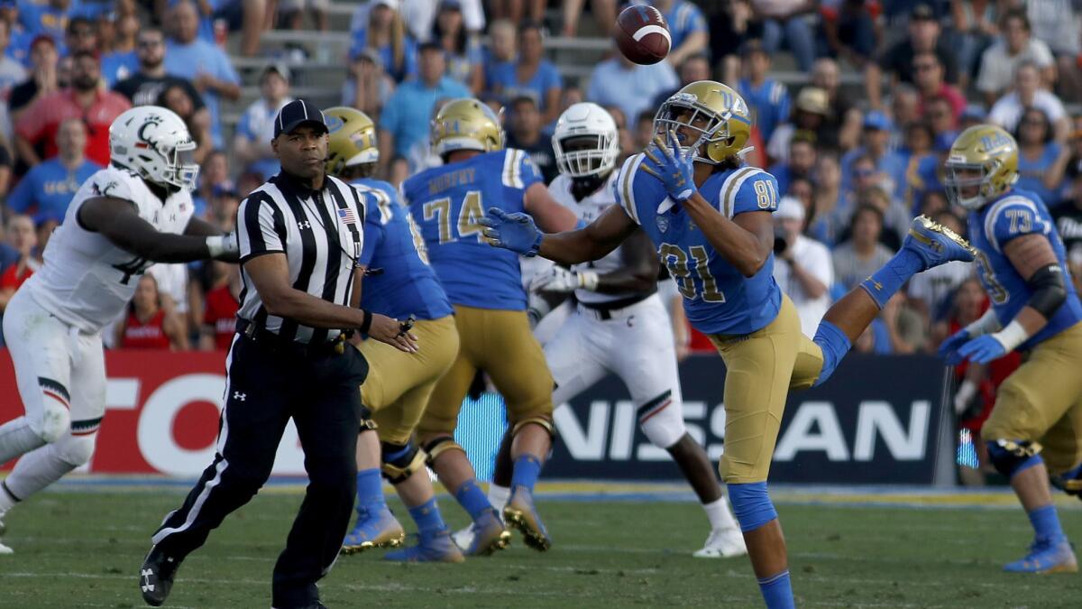 UCLA tight end Caleb Wilson bobbles the ball before making a catch against Cincinnati on Sept. 1.