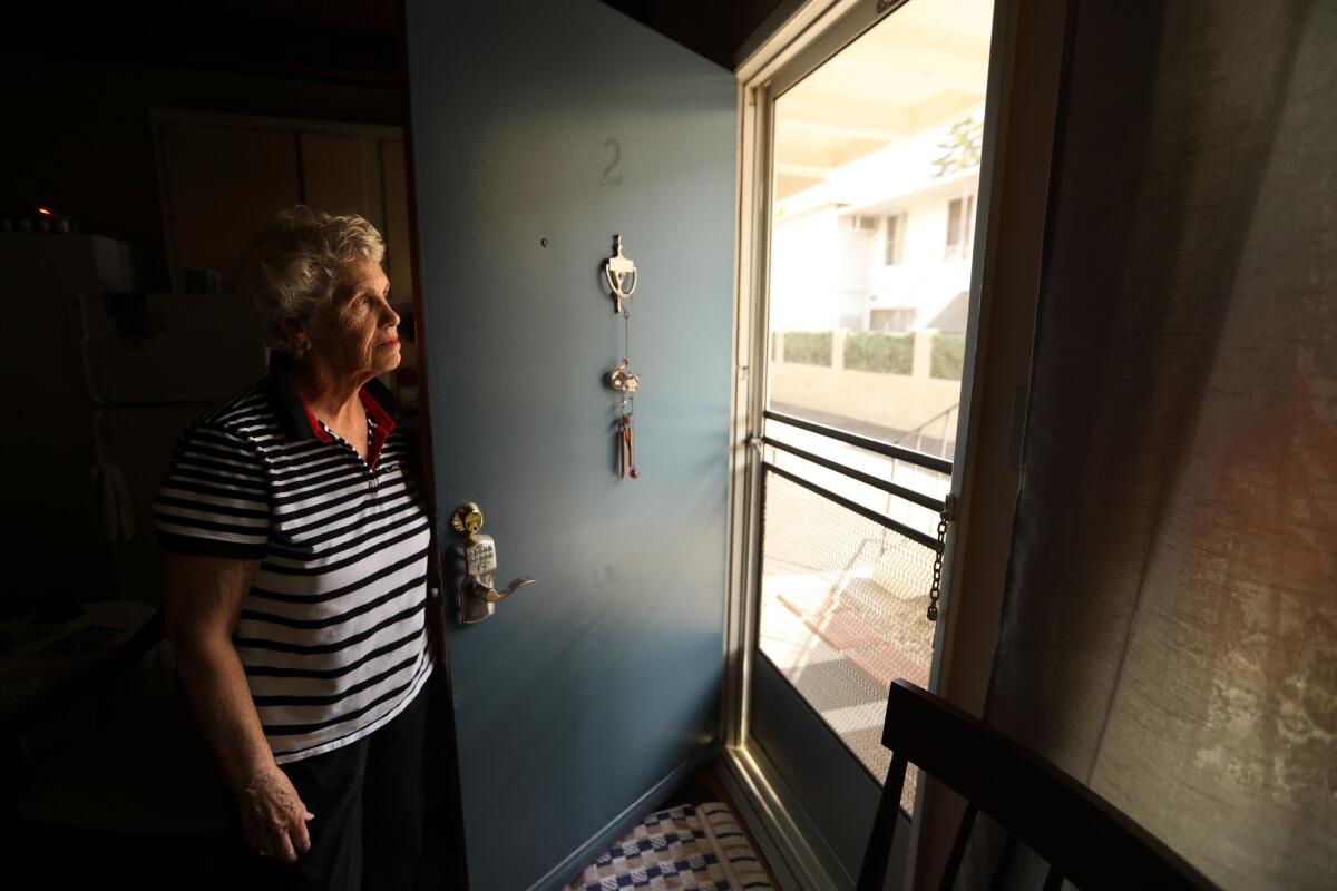 Carol Thompson, 75, looks out the front door of her apartment on N. Detroit Street in Hollywood on Sept. 26, 2018.