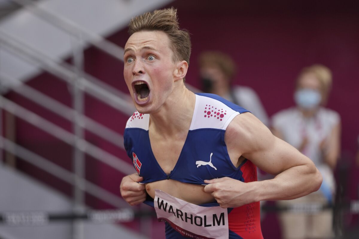 Karsten Warholm, of Norway, celebrates after winning the gold medal in the men's 400-meter hurdles at the 2020 Summer Olympics, Tuesday, Aug. 3, 2021, in Tokyo.(AP Photo/David J. Phillip)