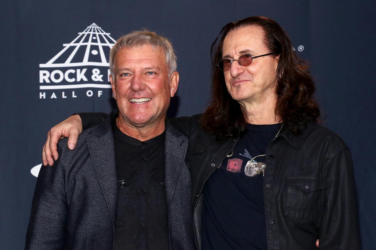 Alex Lifeson and Geddy Lee of Rush attend an event.