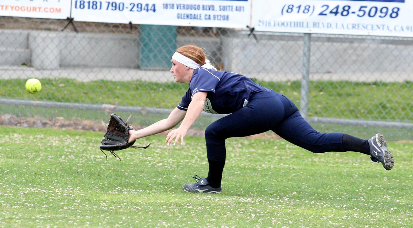 Crescenta Valley's Hannah Cookson dives for the catch in center field against Arcadia in a Pacific League softball game at Crescenta Valley High School on Friday, April 25, 2014. Crescenta Valley won the game 3-1.