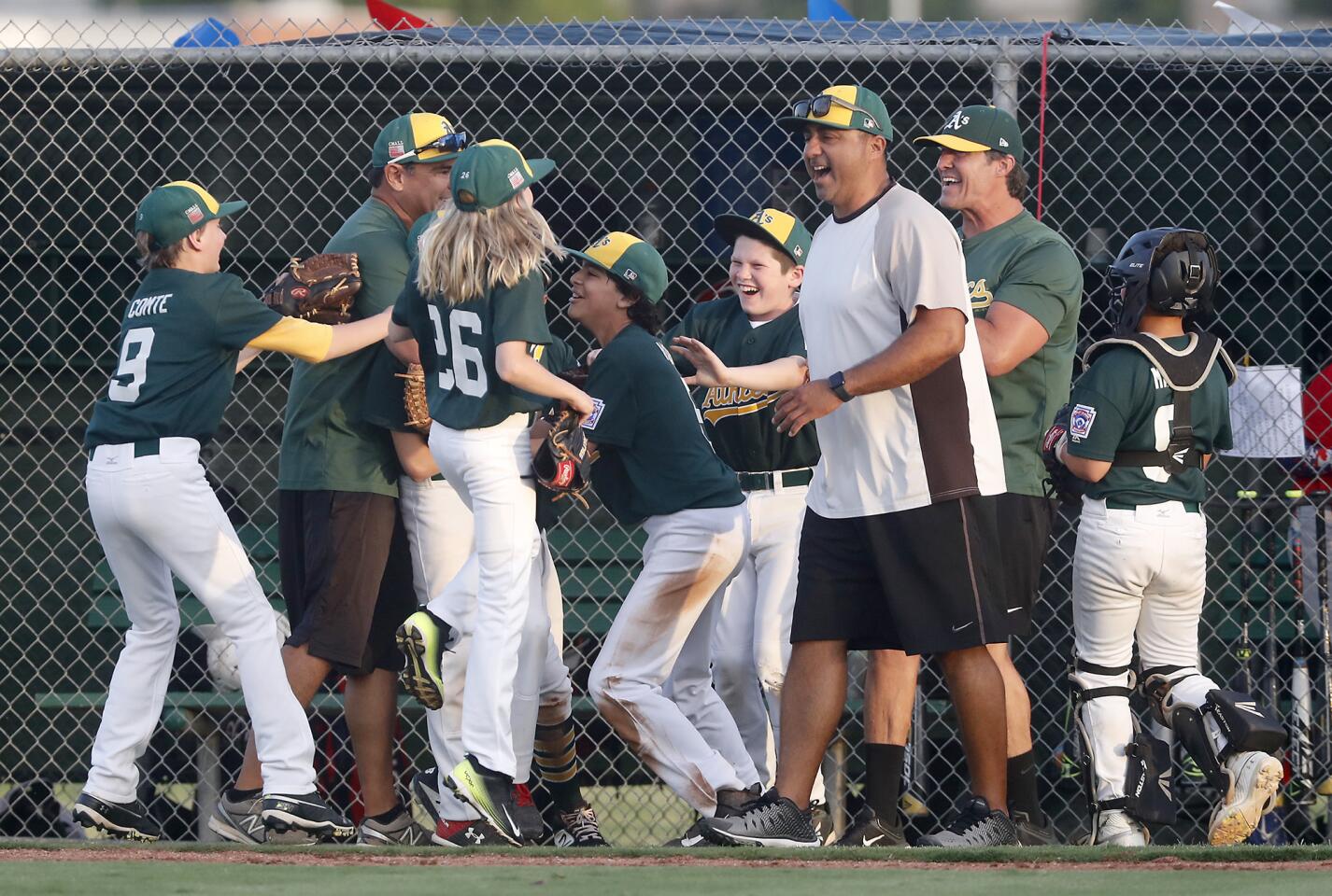 Costa Mesa American Little League's No. 1 team celebrates after beating Ocean View No. 2 in a District 62 Tournament of Champions Major Division quarterfinal game on Tuesday at Costa Mesa American Little League.