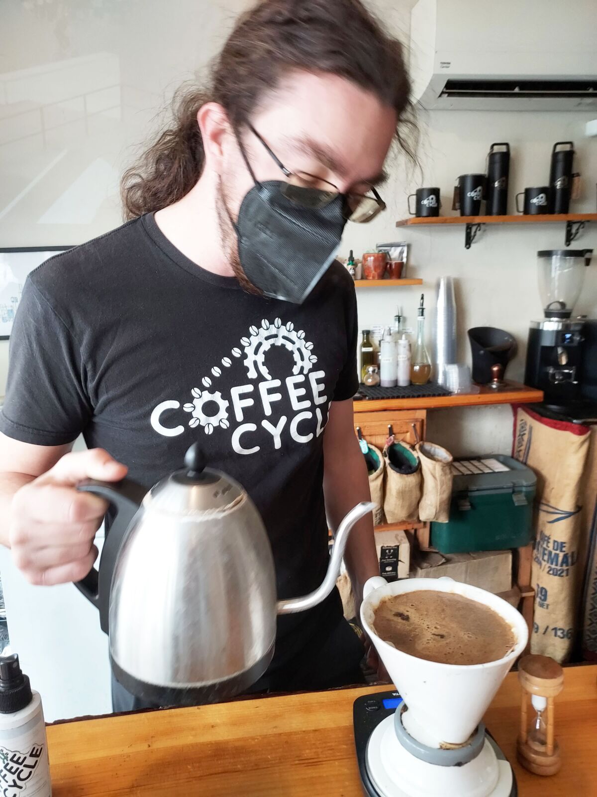 Coffee Cycle owner Chris O’Brien preparing a customer’s order.