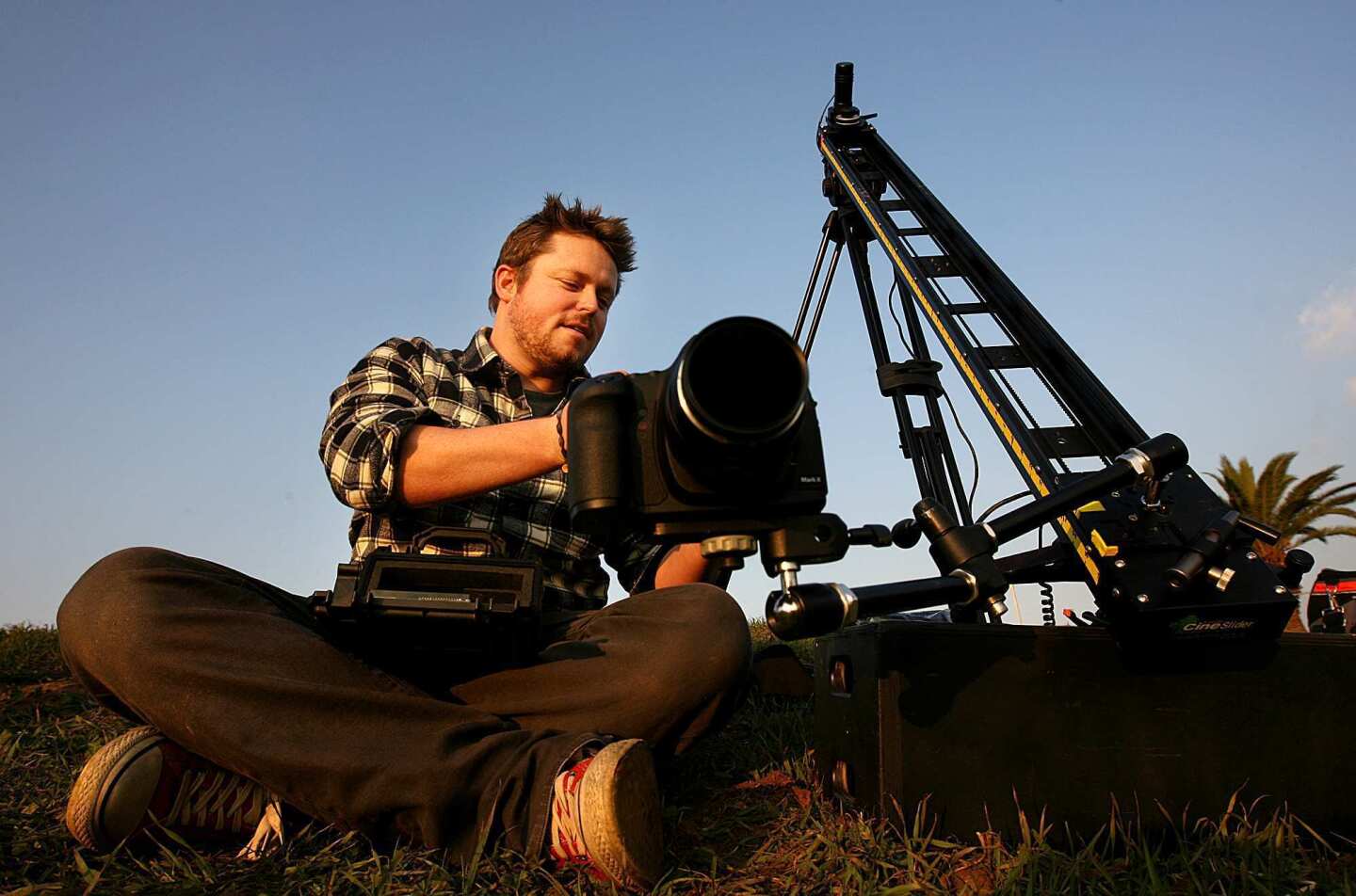 Photographer Colin Rich sets up equipment to shoot a time-lapse sequence of the sun setting on downtown Los Angeles.