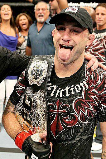 Frankie Edgar celebrates after retaining the UFC lightweight championship belt with a unanimous decision over B.J. Penn on Saturday night at TD Garden in Boston.