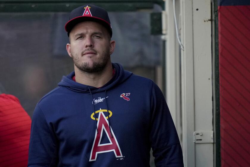Los Angeles Angels Mike Trout walks in the dugout during the first inning of a baseball game against the Colorado Rockies in Anaheim, Calif., Thursday, Aug. 1, 2024. (AP Photo/Eric Thayer)
