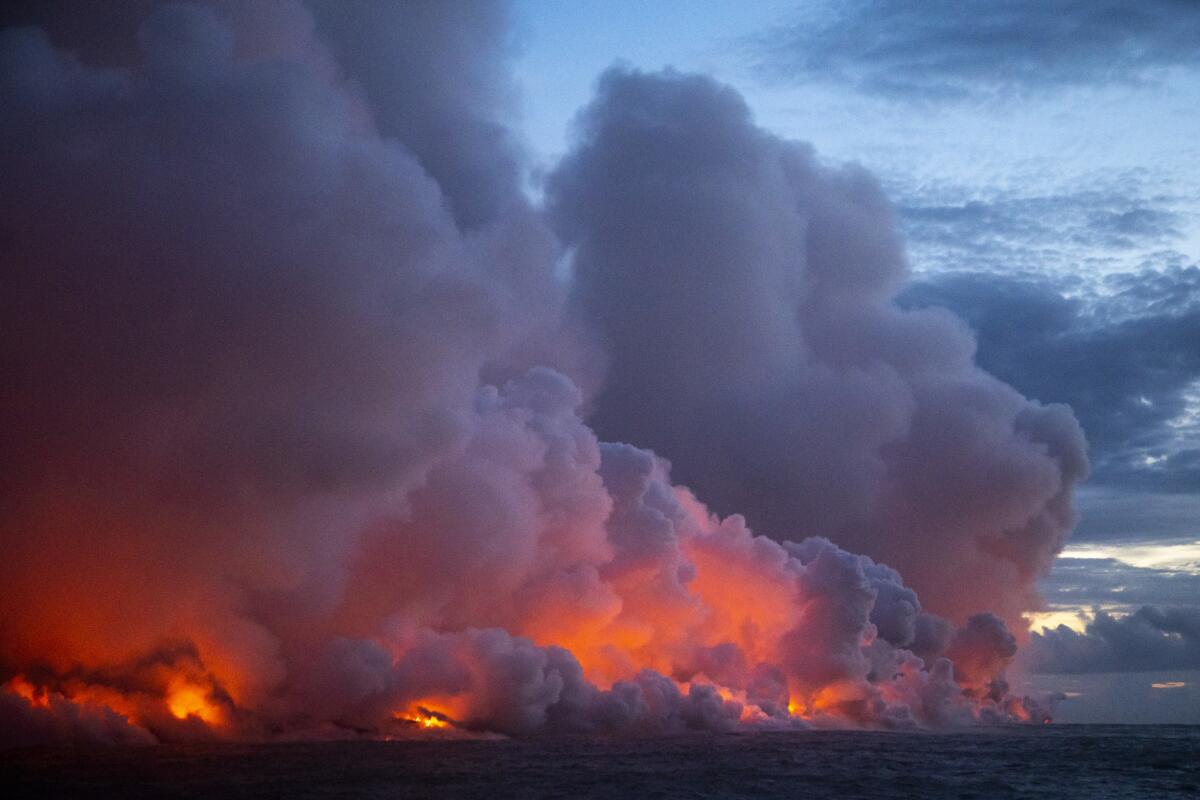 Lava flows into the ocean after traveling down from Fissure 8, one of 22 fissures that opened up after the Kilauea volcano erupted in May.