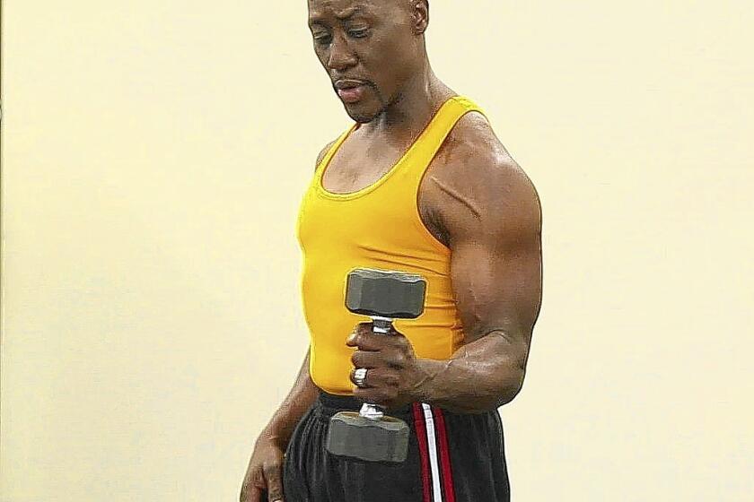 Dr. Levi Harrison demonstrates the rotator cuff exercise with dumbbell.