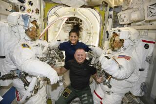 In this photo provided by NASA, Boeing Crew Flight Test astronauts Suni Williams and Butch Wilmore, center, pose with Expedition 71 Flight Engineers Mike Barratt, left, and Tracy Dyson, both NASA astronauts, in their spacesuits aboard the International Space Station's Quest airlock on June 24, 2024. (NASA via AP)