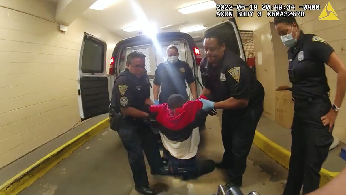 FILE - In this image taken from police body camera video provided by New Haven Police, Richard "Randy" Cox, center, is pulled from the back of a police van and placed in a wheelchair after being detained by New Haven Police on June 19, 2022, in New Haven, Conn. Five Connecticut police officers were charged with misdemeanors Monday, Nov. 28, over their treatment of Cox after he was paralyzed from the chest down in the back of a police van. (New Haven Police via AP, File)