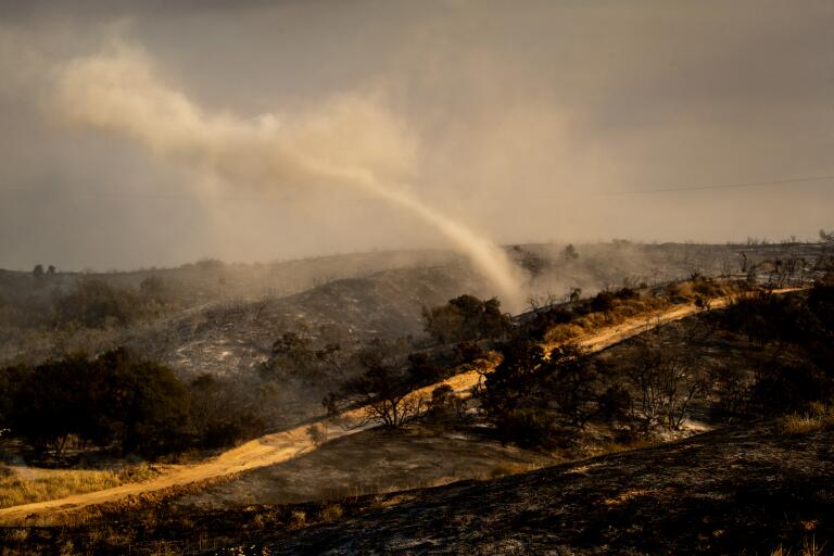 Photos: Fast-moving fires force evacuations, char thousands of acres in ...