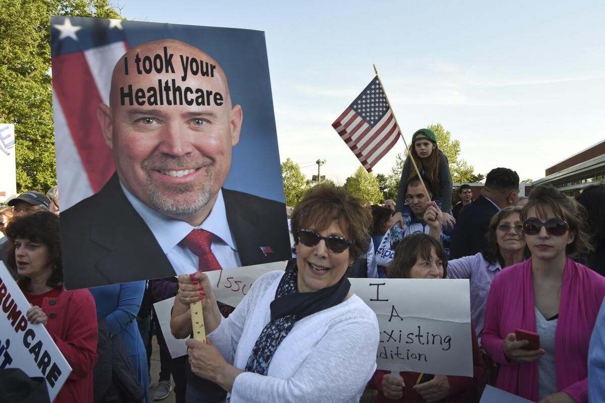 Barbara Blonsky of Mt. Laurel, N.J., protests outside a town meeting held by Rep. Tom MacArthur in Willingboro, N.J., on May 10.