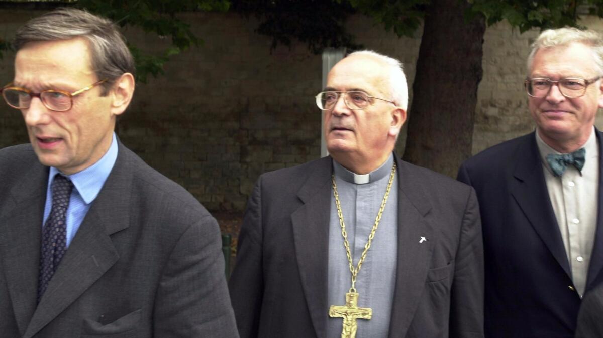 Bishop Pierre Pican, center, flanked by lawyers outside the Caen court house in France in 2000. (Mychele Daniau / AFP/ Getty Images)