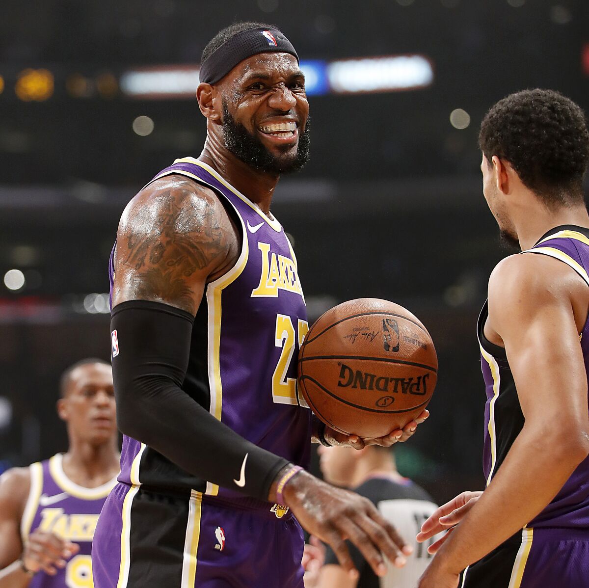 Lakers forward LeBron James celebrates a basket against the Timberwolves by teammate Josh Hart.