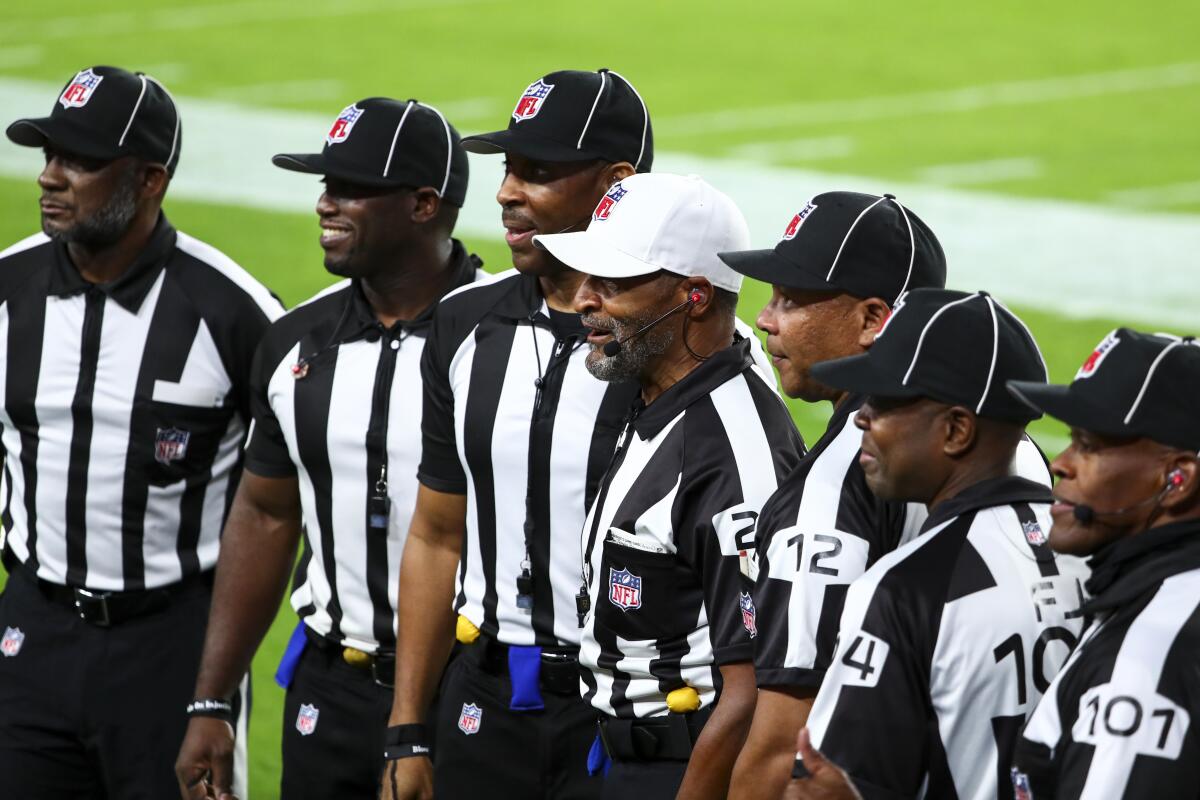 NFL officials pose for a photo before Monday's game between the Rams and Buccaneers.