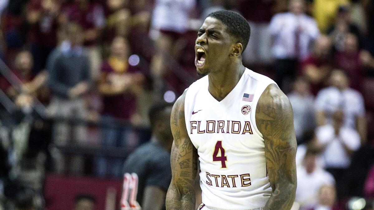 Florida State guard Dwayne Bacon reacts to a teammate's three-point basket against Louisville during the first half Saturday.