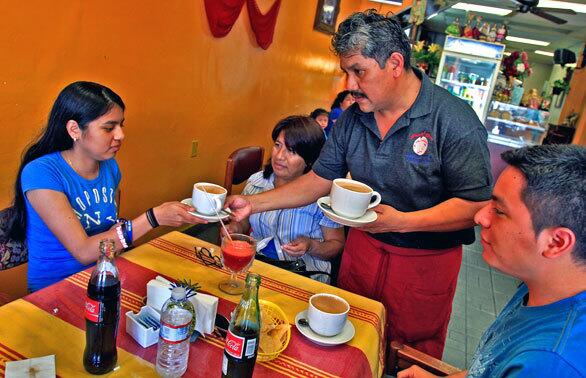 David Padilla serves Mexican Coca-Cola and hot chocolate de agua at Gish Bac, on Washington Boulevard near Crenshaw.