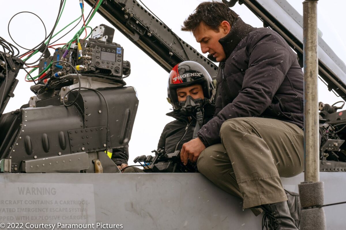Monica Barbaro and Tom Cruise on the set