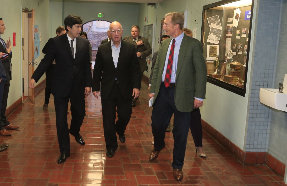 Gov. Jerry Brown, center, Senate President Pro Tem Kevin de León, left, and billionaire green activist Tom Steyer visit John Marshall High School, the first in the L.A. school district to receive Proposition 39 funding for energy efficiency projects.