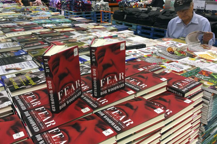 FILE - In this Sept. 11, 2018 file photo, copies of Bob Woodward's "Fear" appear at Costco in Arlington, Va. Woodward's hottest seller in years, read like a more sober version of "Fire and Fury," another tale of an uncontrollable chief executive and a staff that tries both to contain and encourage him. (AP Photo/Pablo Martinez Monsivais, File)