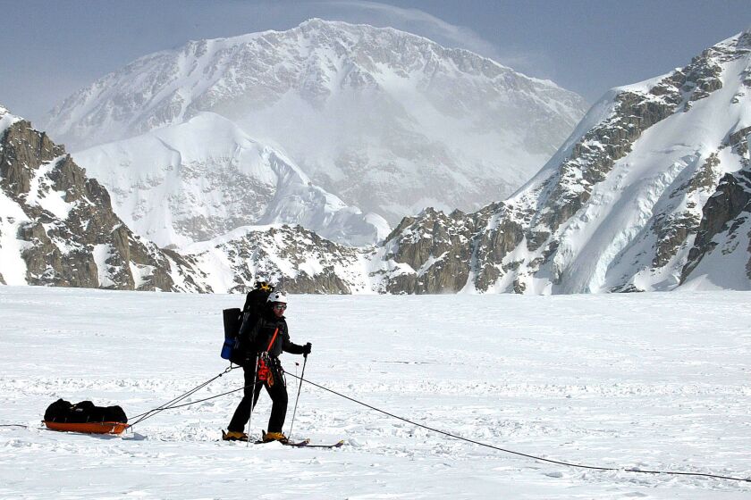 A skier moves across the Kahiltna Glacier in Alaska with Mt. McKinley in the background in 2002.
