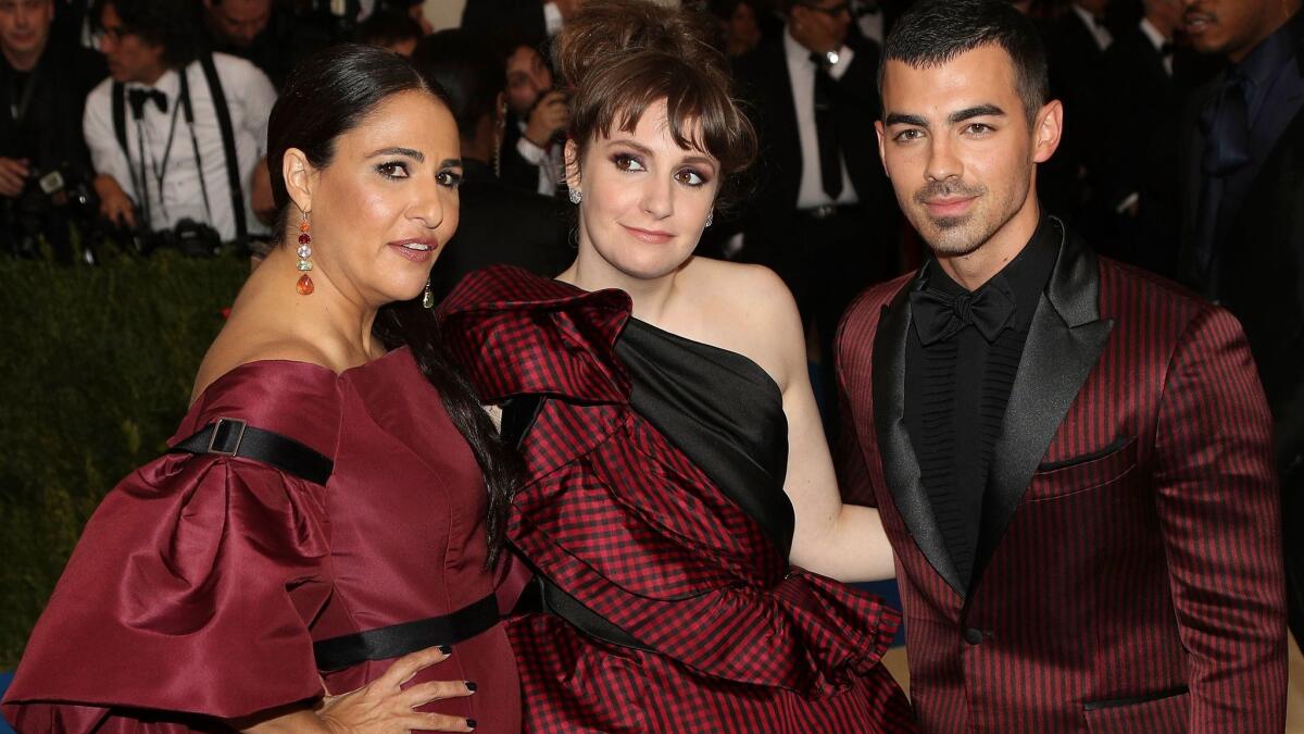 Jenni Konner, from left, Lena Dunham and Joe Jonas arrive on the 2017 Met Gala red carpet on May 1, 2017.