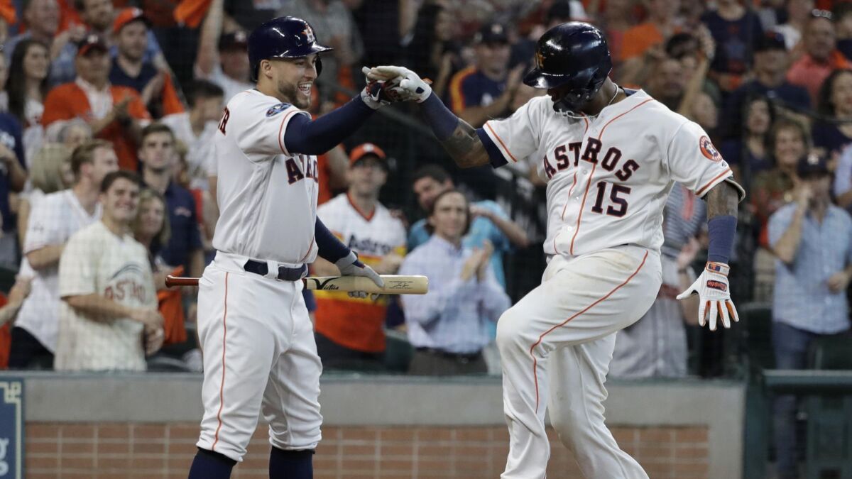 Martin Maldonado celebrates his solo home run against the Cleveland Indians with teammate George Springer.