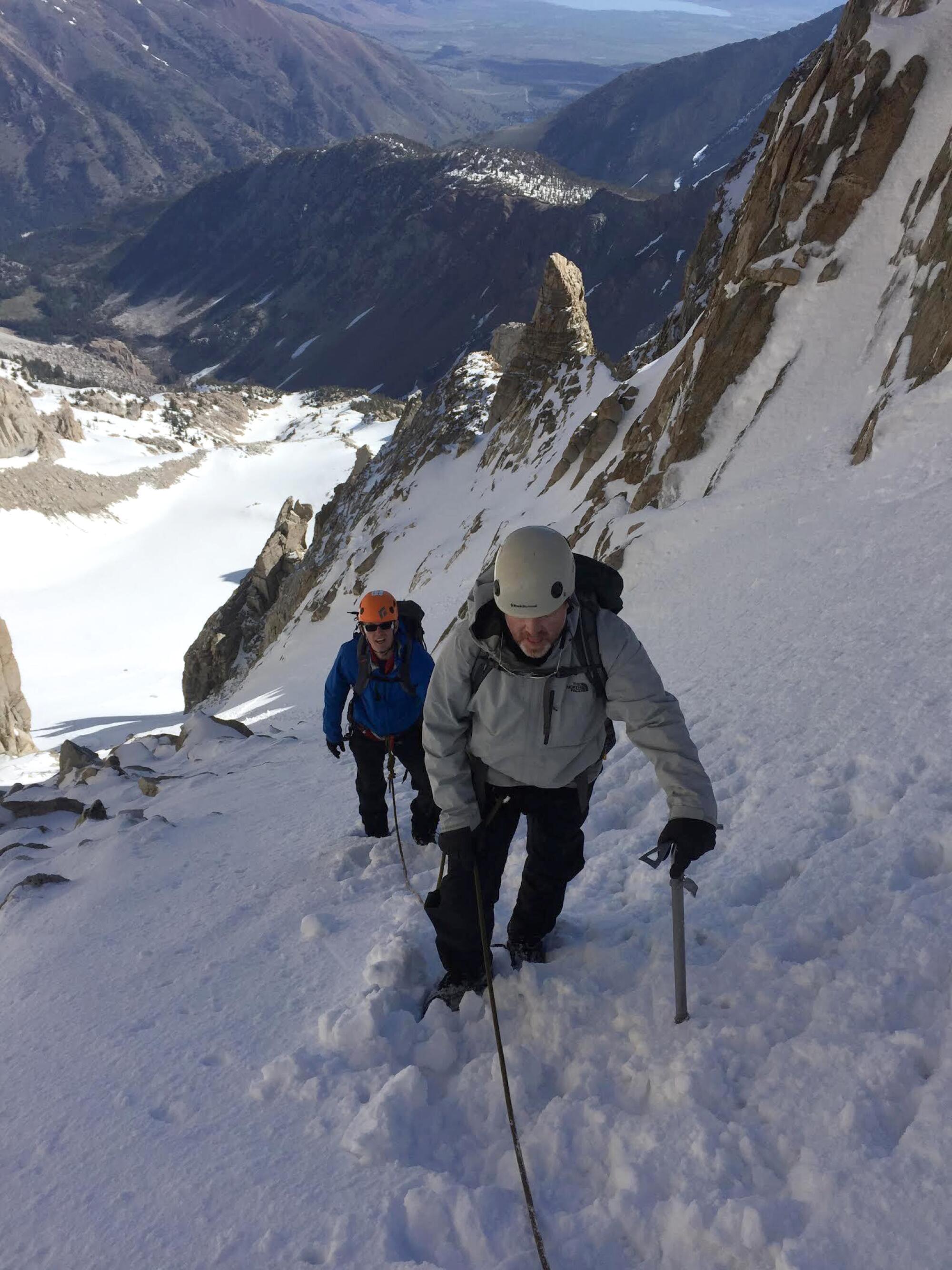 Two climbers roped together on a slope