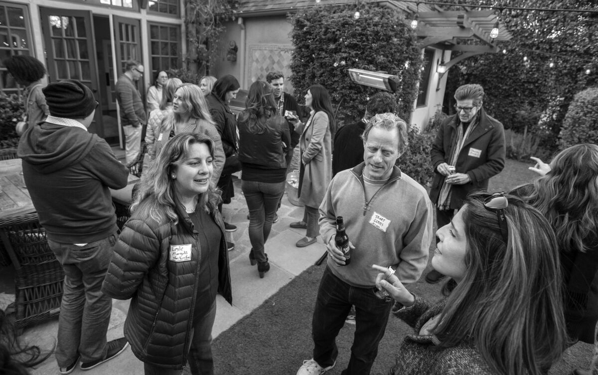 Writers hang out on the backyard patio at the home of Stuart Gibbs.