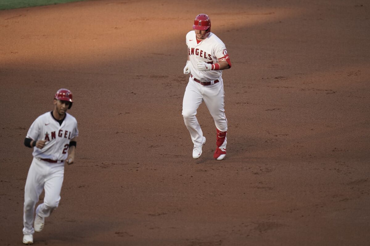 The Angels' Mike Trout and Andrelton Simmons round the bases on Trout's two-run homer.