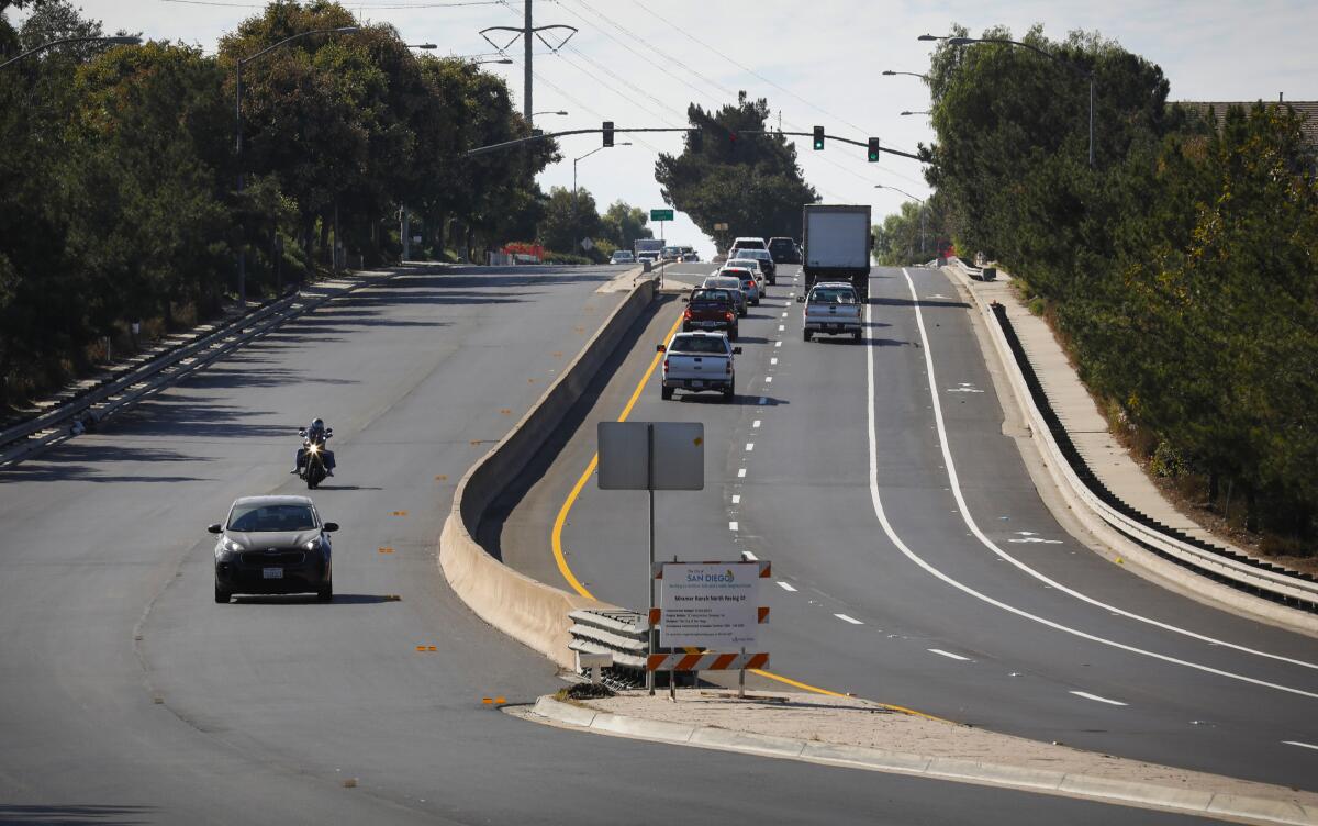 Cars travel on a road being repaved in San Diego in 2020.