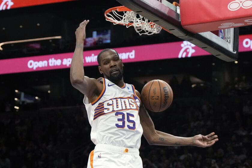 Phoenix Suns forward Kevin Durant dunks against the Philadelphia 76ers during the second half of an NBA basketball game Wednesday, March 20, 2024, in Phoenix. (AP Photo/Rick Scuteri)