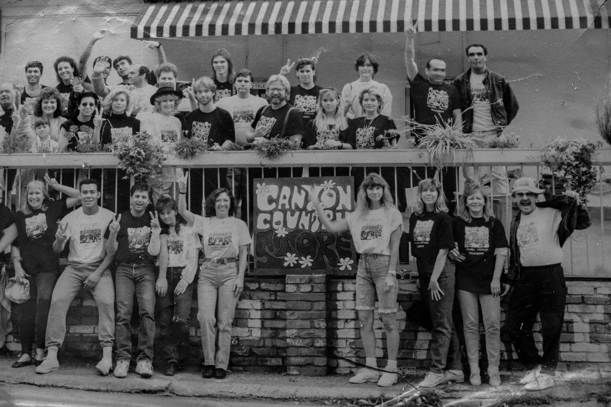 A black-and-white image of a neighborhood group shot in front of the Canyon Country store.